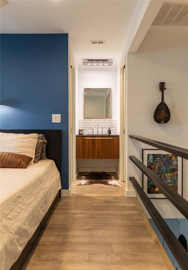 bedroom featuring wood-type flooring