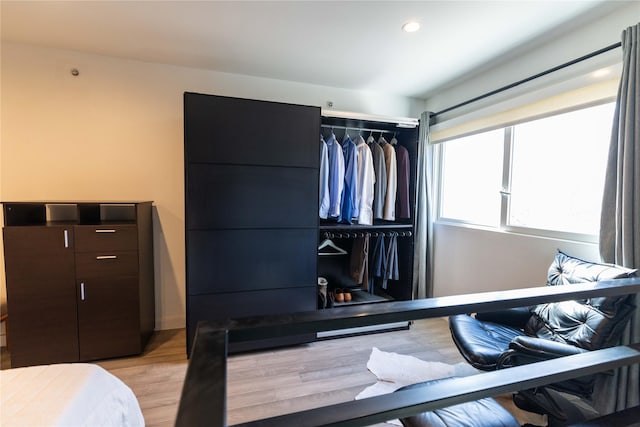 bedroom with a closet and light hardwood / wood-style flooring