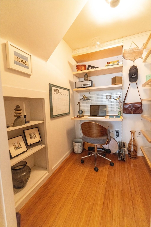 home office with light hardwood / wood-style flooring