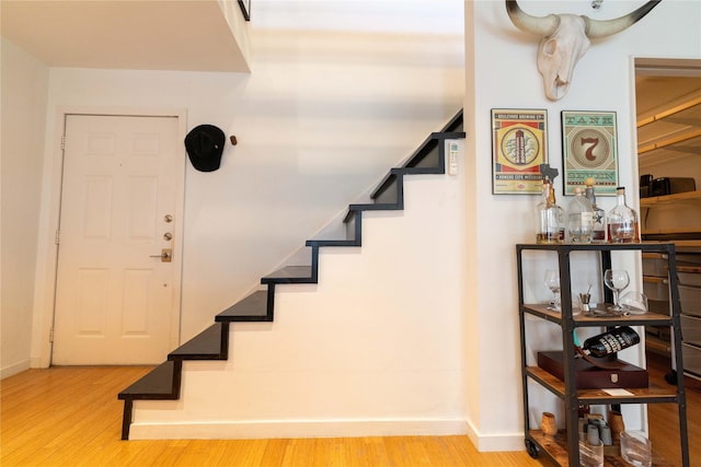 staircase with hardwood / wood-style floors