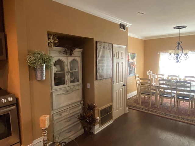 interior space featuring dark hardwood / wood-style floors, crown molding, and a notable chandelier