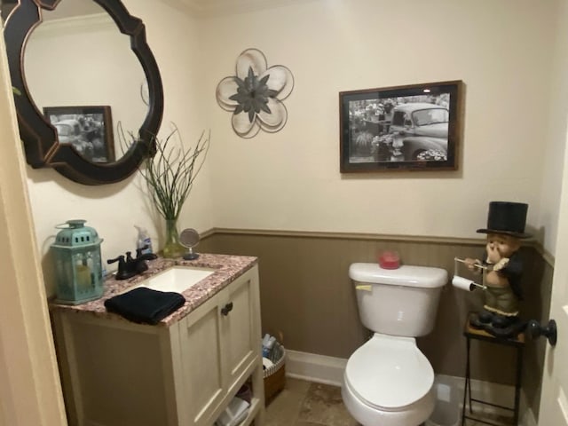 bathroom featuring toilet, ornamental molding, tile patterned floors, and vanity