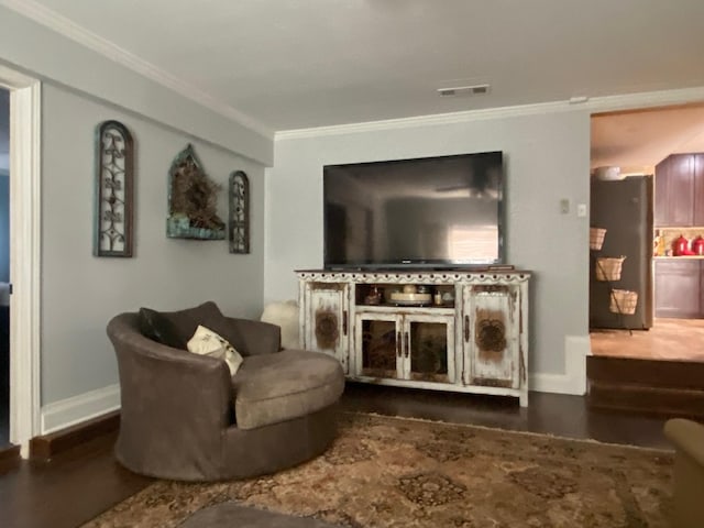 living room featuring dark wood-type flooring and ornamental molding