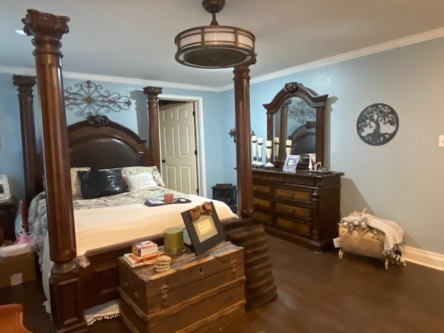 bedroom with decorative columns, dark hardwood / wood-style floors, and crown molding