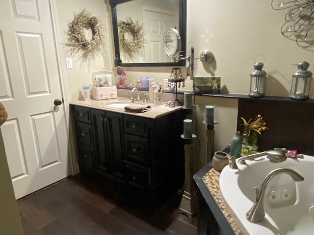 bathroom featuring wood-type flooring, vanity, and a washtub