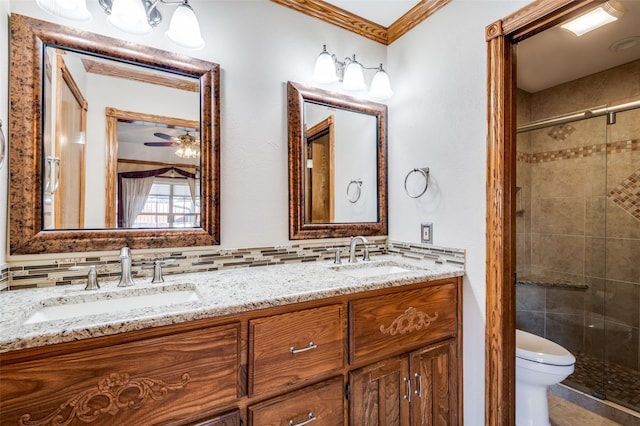 bathroom with an enclosed shower, vanity, backsplash, toilet, and ornamental molding