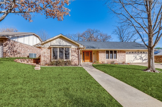 single story home with a garage, a front lawn, and central AC unit