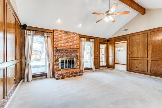 unfurnished living room featuring light carpet, a brick fireplace, plenty of natural light, and lofted ceiling with beams