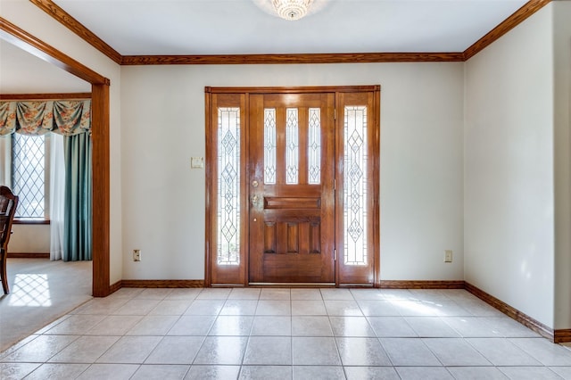 foyer entrance featuring light tile patterned floors and ornamental molding