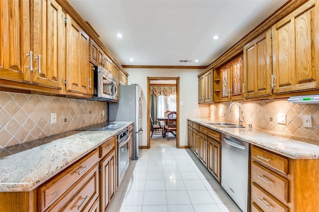 kitchen featuring tasteful backsplash, sink, stainless steel appliances, light tile patterned floors, and light stone counters