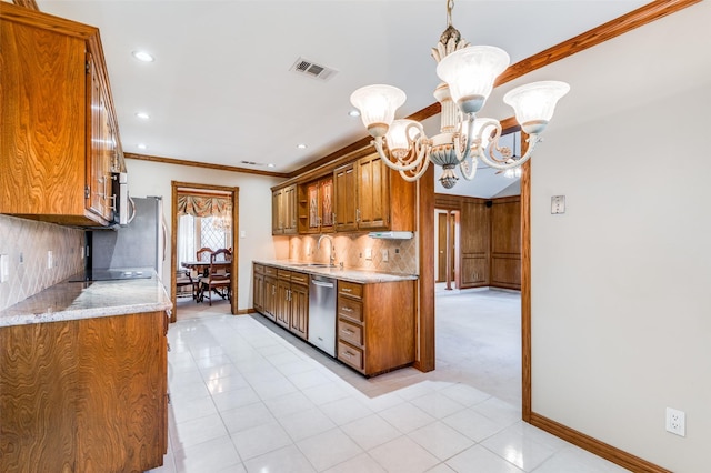 kitchen featuring appliances with stainless steel finishes, backsplash, a notable chandelier, decorative light fixtures, and ornamental molding