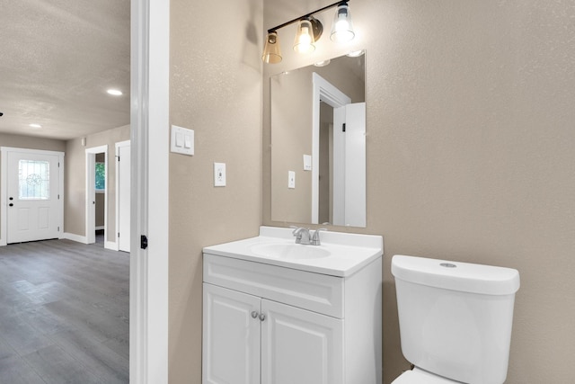 3482 Bandera Rd, Fort Worth, TX 76116 - half bath with toilet, vanity, wood finished floors, recessed lighting, and baseboards