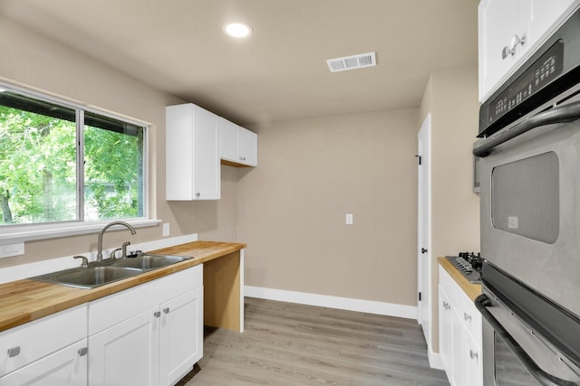 3482 Bandera Rd, Fort Worth, TX 76116 - kitchen with a sink, wooden counters, white cabinetry, light wood-style floors, and recessed lighting