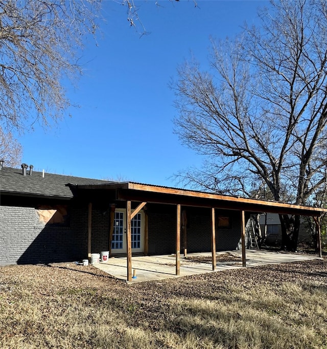3482 Bandera Rd, Fort Worth, TX 76116 - back of property with a patio area, brick siding, and an attached carport