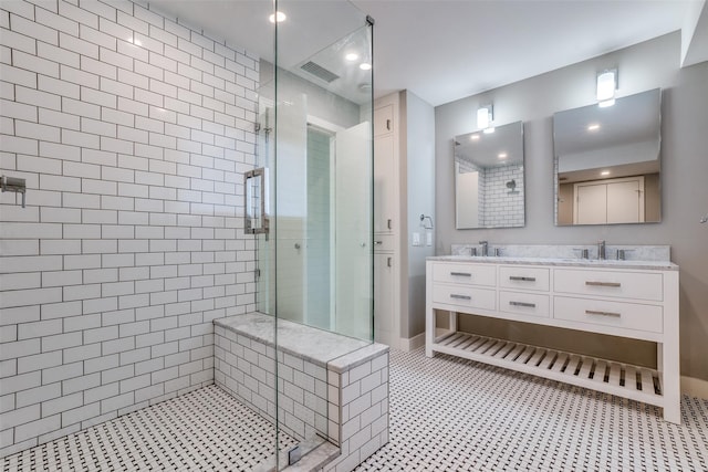 bathroom featuring an enclosed shower and vanity