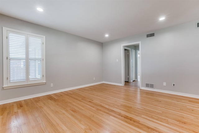 spare room featuring light wood-type flooring and a wealth of natural light