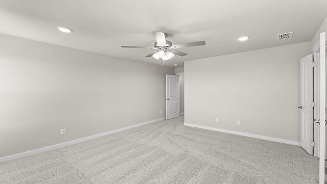 empty room with baseboards, visible vents, light colored carpet, ceiling fan, and recessed lighting