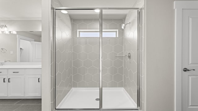 bathroom featuring a stall shower, tile patterned flooring, and vanity