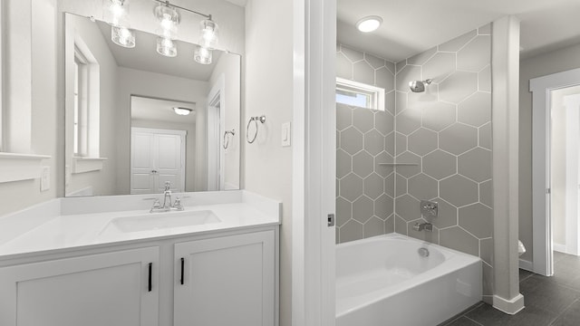 bathroom featuring shower / tub combination, baseboards, tile patterned flooring, and vanity