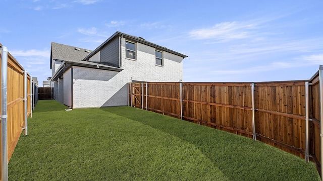 view of yard with a fenced backyard