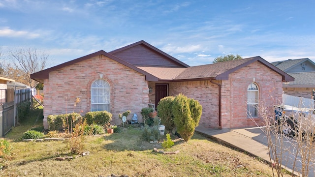 ranch-style home with a front lawn