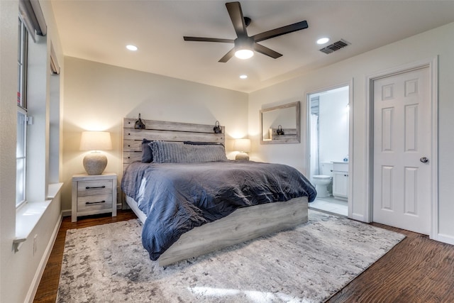 bedroom featuring ensuite bathroom, ceiling fan, and dark wood-type flooring