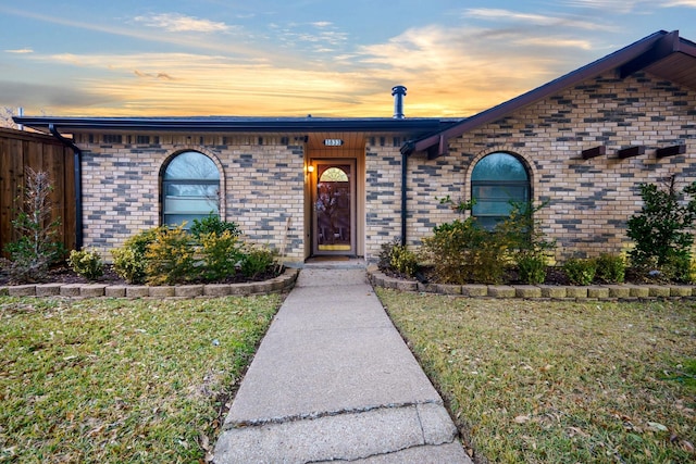 ranch-style house with a lawn