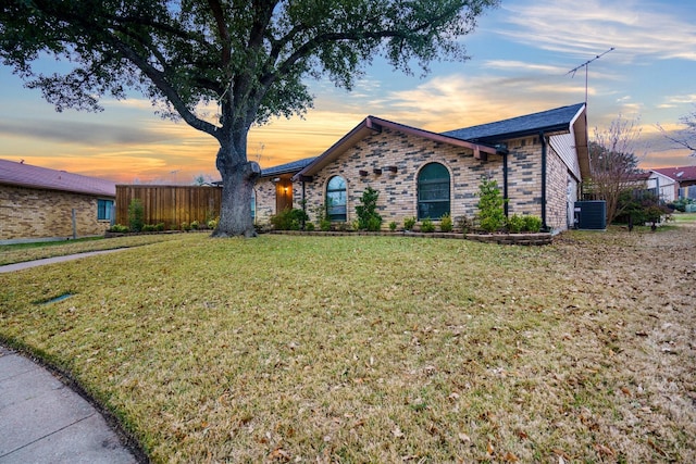 single story home with central AC and a yard