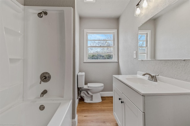 full bathroom with vanity, hardwood / wood-style flooring, shower / tub combination, and toilet