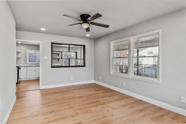 unfurnished room featuring light hardwood / wood-style floors and ceiling fan