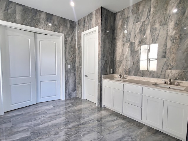 bathroom with tile walls and vanity