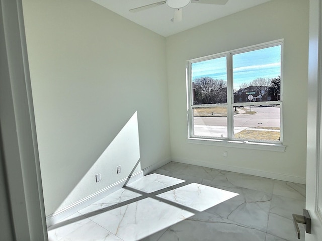 unfurnished room featuring ceiling fan and plenty of natural light