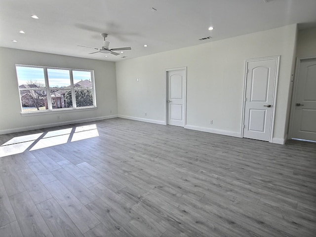 spare room featuring ceiling fan and light hardwood / wood-style flooring