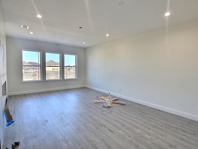 spare room with light hardwood / wood-style floors