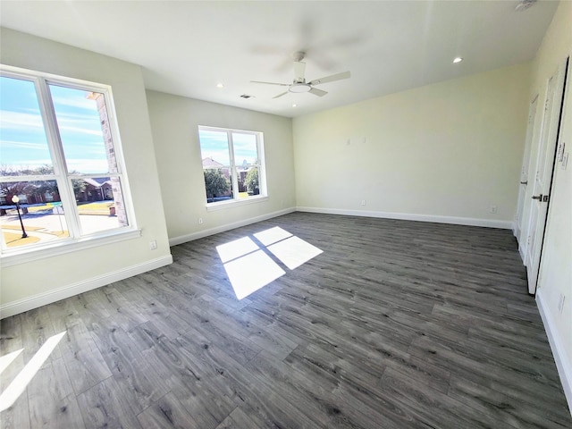 unfurnished room featuring dark wood-type flooring and ceiling fan