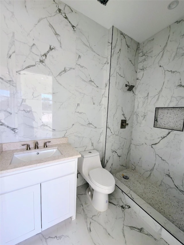 bathroom with toilet, vanity, tile walls, and a tile shower