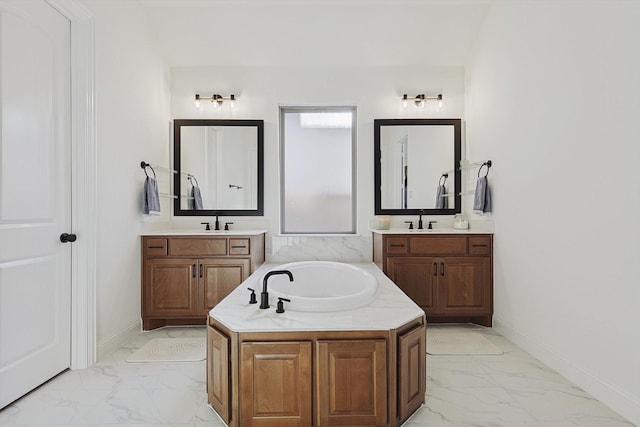 bathroom with vanity and a tub