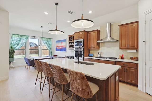 2613 Somerset Ln, Celina, TX 75009 - kitchen with wall chimney exhaust hood, stainless steel appliances, brown cabinetry, light countertops, and backsplash