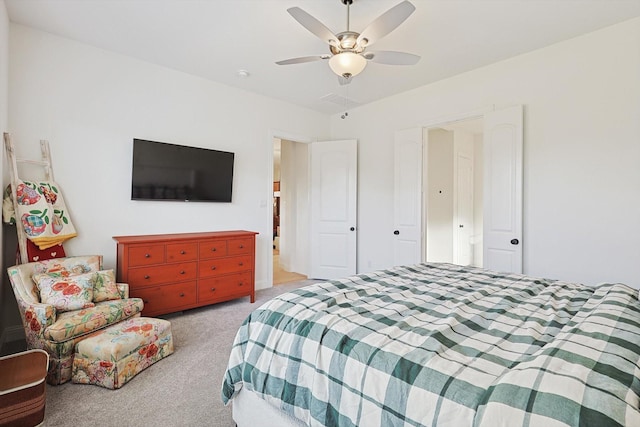 bedroom with ceiling fan and light carpet