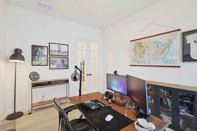 office with wood-type flooring and french doors