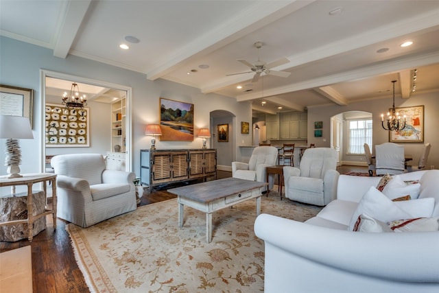 living room with ceiling fan with notable chandelier, hardwood / wood-style floors, crown molding, and beamed ceiling