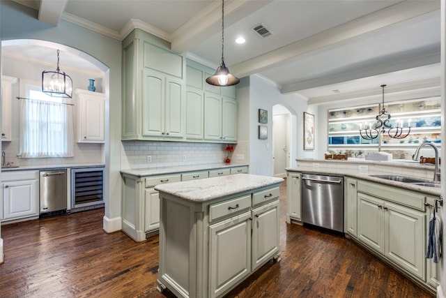 kitchen featuring dishwasher, beverage cooler, a kitchen island, light stone counters, and sink