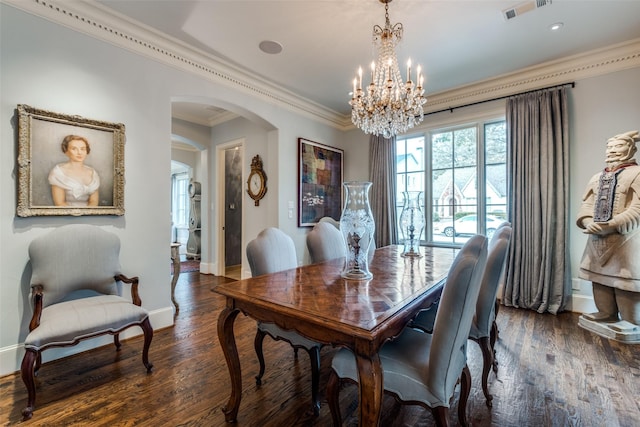 dining space with dark hardwood / wood-style floors, an inviting chandelier, and ornamental molding