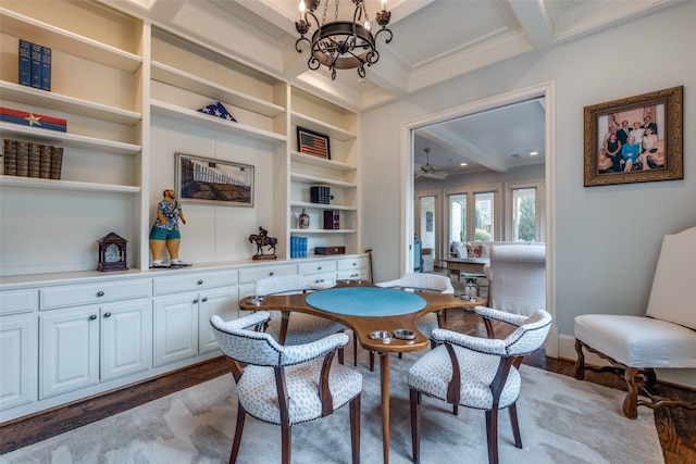 dining room with dark wood-type flooring, built in shelves, beamed ceiling, a notable chandelier, and crown molding