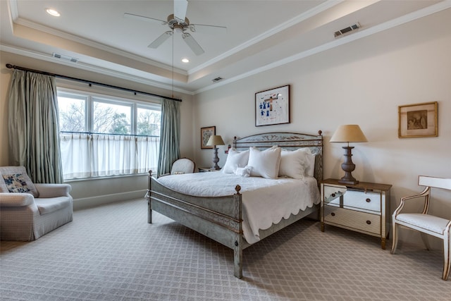 bedroom with ceiling fan, carpet, and a tray ceiling