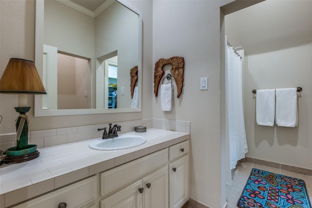 bathroom with tile patterned floors, vanity, and crown molding