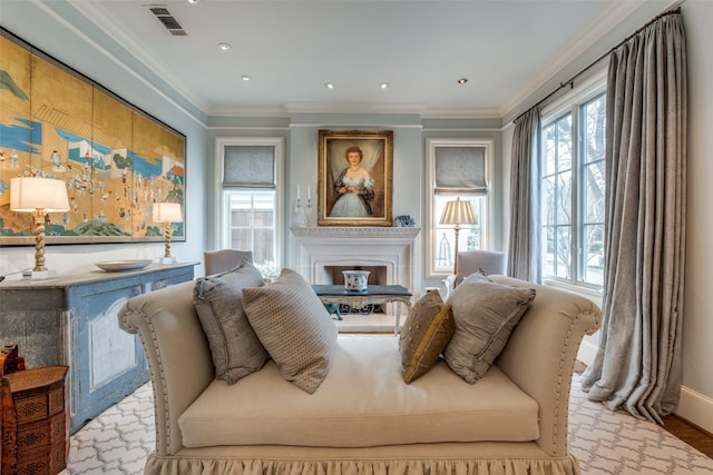 sitting room featuring light hardwood / wood-style flooring and crown molding