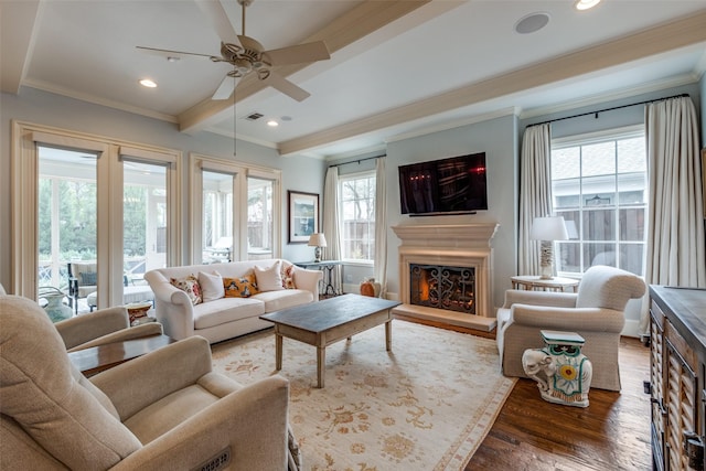 living room with ceiling fan, crown molding, beam ceiling, and dark hardwood / wood-style floors