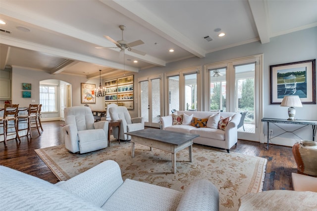 living room featuring ceiling fan with notable chandelier, crown molding, beam ceiling, and dark hardwood / wood-style floors