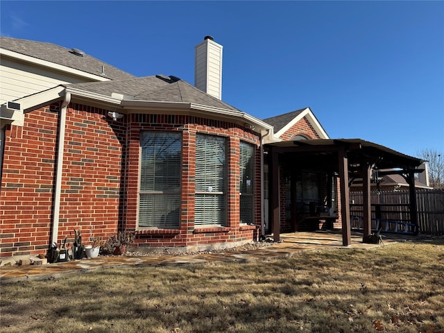 back of property with a patio area and a lawn